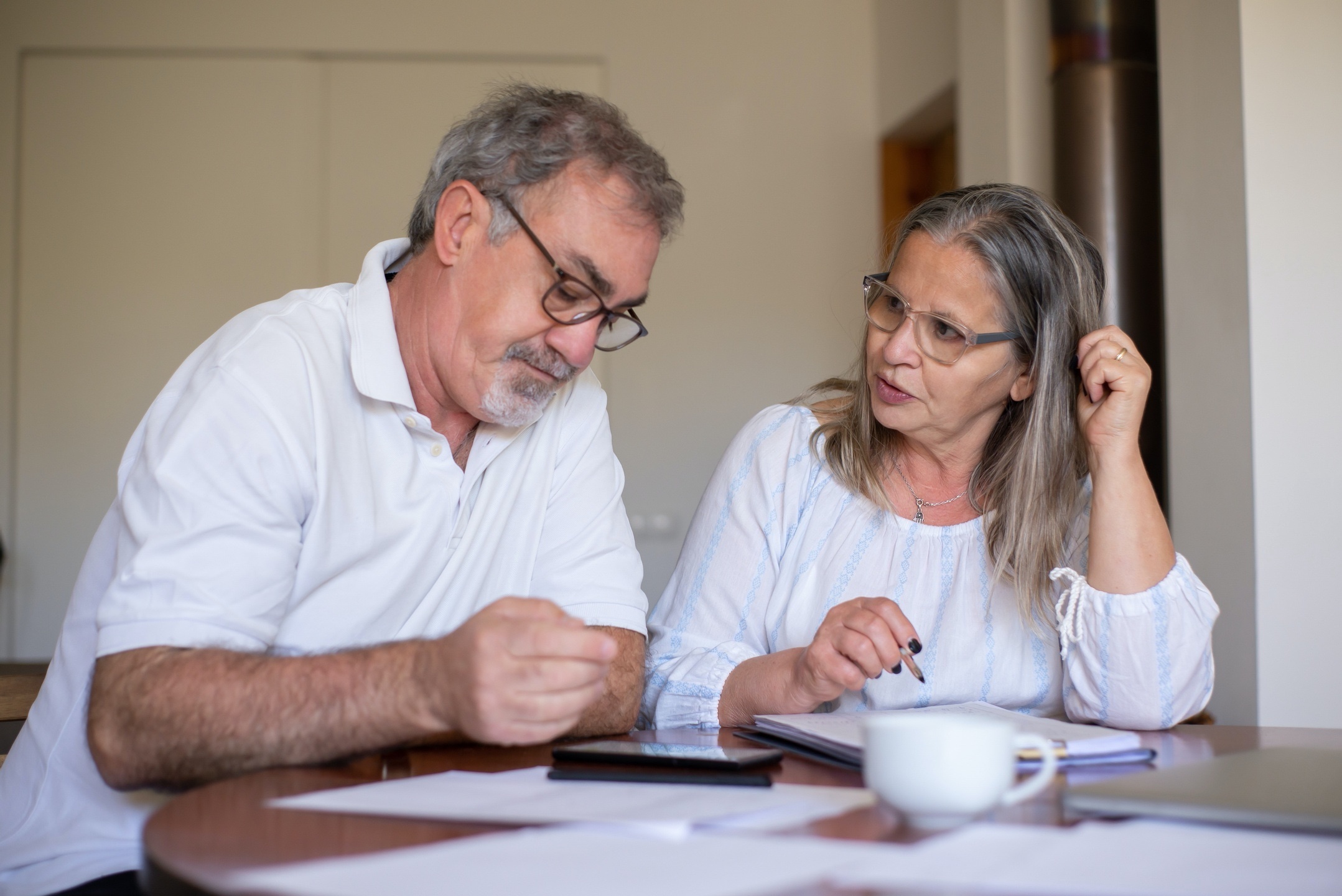 Two people reviewing paperwork together at a table