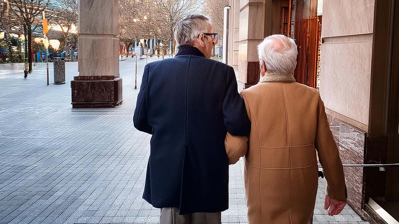 An older couple walking together