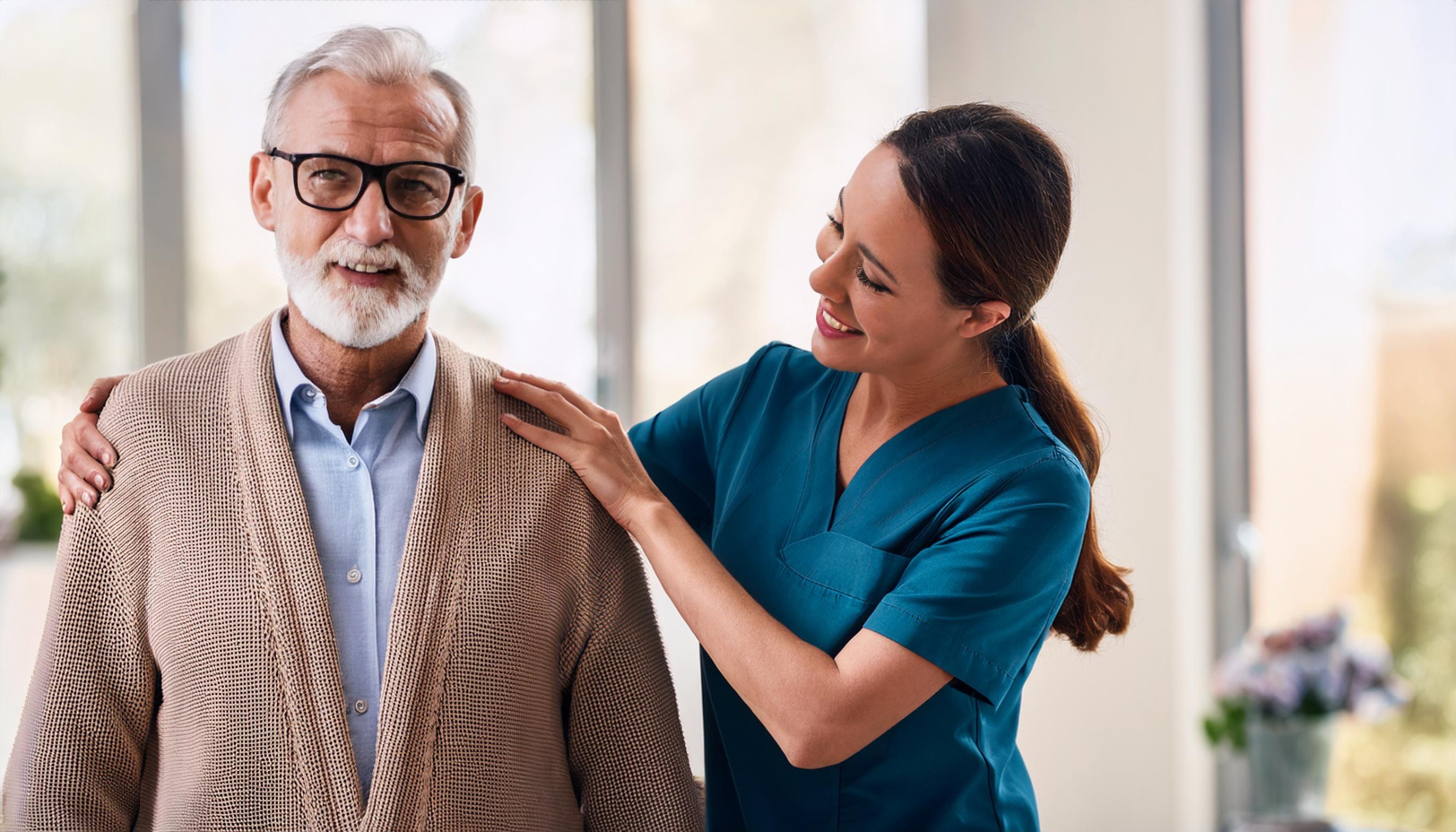 A female carer reassuring an older man